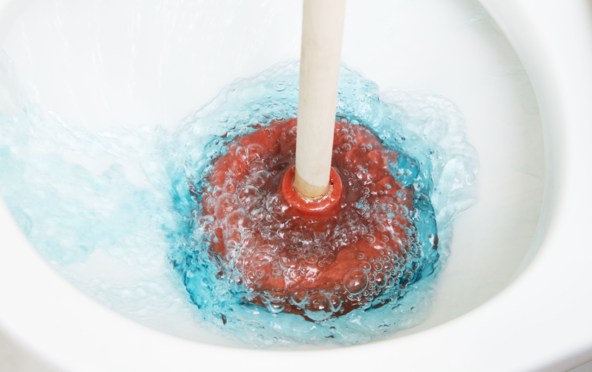 Plunging a clogged toilet