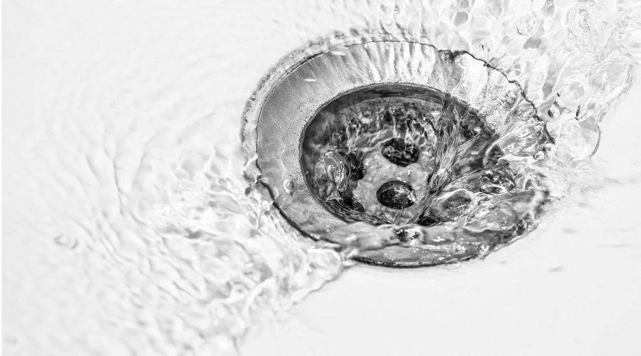 Water swirling down a sink drain.